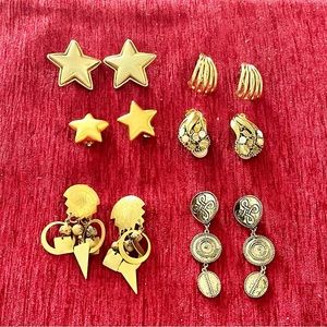 6 pair of gold clip earrings.